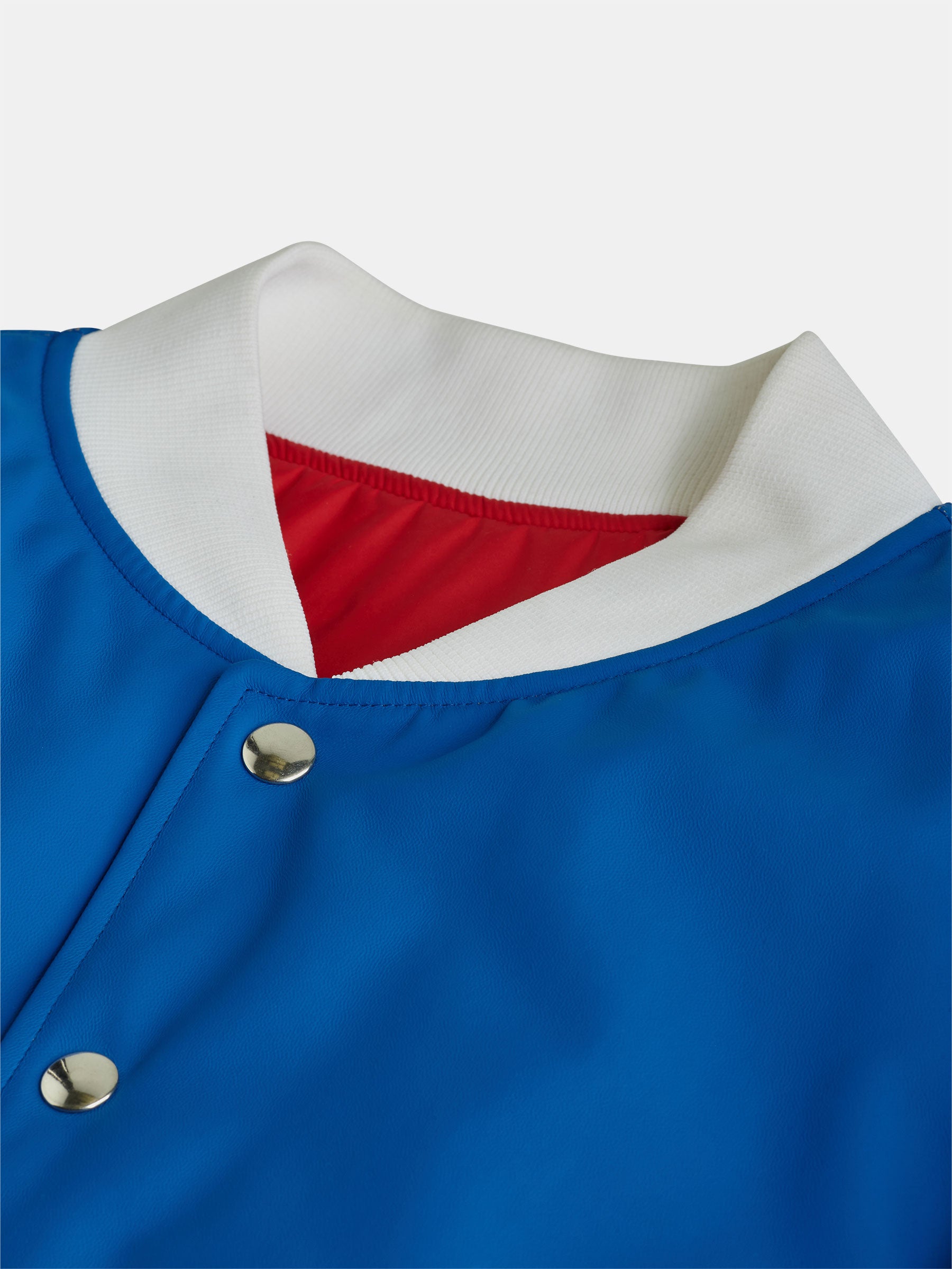 Close-up of the Blue Bomber Jacket by gabrielstunz, showcasing its white ribbed collar and luxurious red lining. Crafted from premium technical fabrics, it features sleek metallic snap buttons.