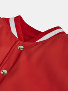 Close-up of the Red College Jacket with Beige Twill Sleeves by gabrielstunz, showcasing its red and white striped ribbed collar and premium craftsmanship. This classic collegiate style piece is highlighted by silver snap buttons on the front.