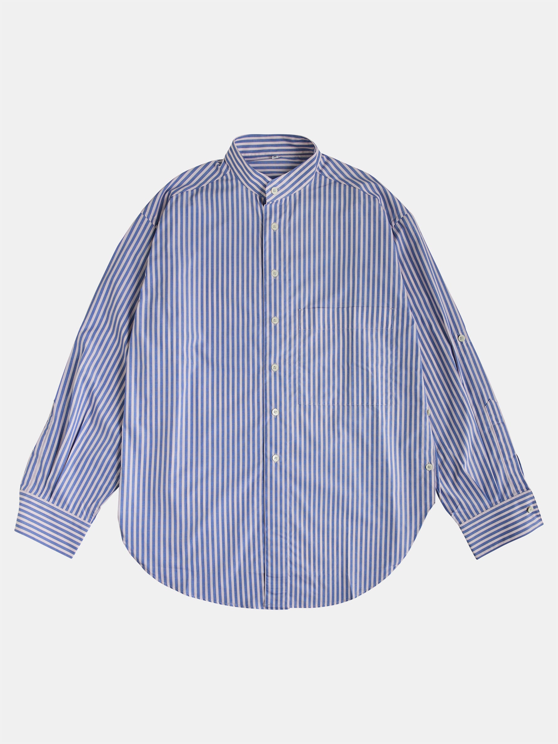 The Oversized Mao Collar Shirt from gabrielstunz showcases a contemporary design with light blue and pink vertical stripes. Crafted from premium fabric, this long-sleeve shirt features a sleek Mao collar and button cuffs, all set against a plain light background.