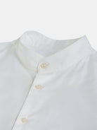 Displayed is a POCKETPARACHUTE® Shirt by gabrielstunz, featuring a white hue and mandarin collar. The shirt showcases visible buttons crafted from clean, crisp premium fabric. Set against a plain, light background, its modern fit underscores the simplicity and elegance of the design.