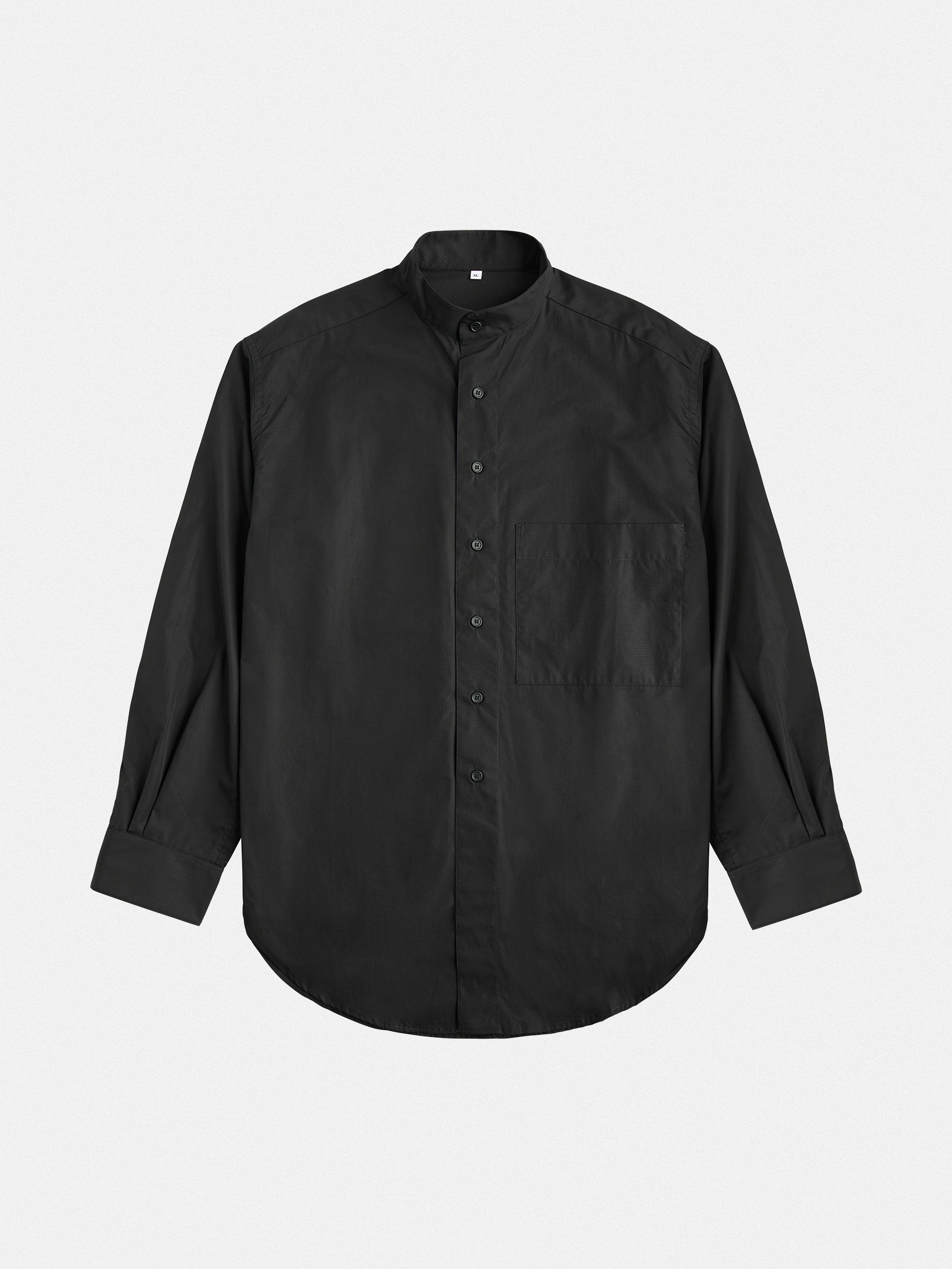 An oversized cotton shirt by gabrielstunz, colored in black with long sleeves and a left-side pocket. Expertly crafted from premium cotton, it is displayed flat on a white background, highlighting its rounded hem and subtle collar that exemplify European craftsmanship.