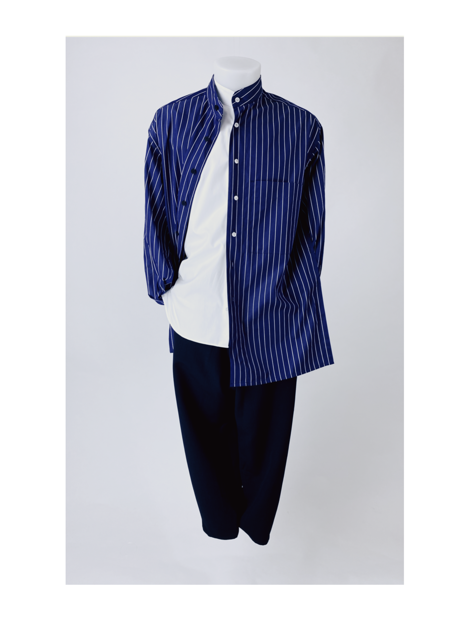 A mannequin dressed in a blue and white pinstripe shirt with a white undershirt, paired with black pants against a plain white background. The mannequins head and legs are not visible.