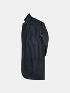 Side view of a navy, long-sleeved Original POCKETPARACHUTE® Travel Blazer by gabrielstunz on a plain white background. The blazer features large front pockets and buttons along the front, crafted from water-repellent fabric that appears smooth and slightly glossy. Its packable design enhances convenience for travel.