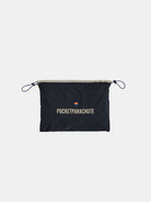 A water-repellent pouch, inspired by the gabrielstunz Original POCKETPARACHUTE® Travel Blazer Navy's packable design, showcases a stylish combination of a black body with a beige top. It features an elegantly centered small logo, above the white text "POCKETPARACHUTE," and includes adjustable drawstrings on both sides for added convenience.