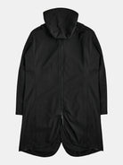 The POCKETPARACHUTE® Raincoat by gabrielstunz, featuring a sleek black design, is water-repellent and packable. It is laid flat and viewed from the back, showcasing a center zipper and a slightly longer hem at the back for enhanced coverage.