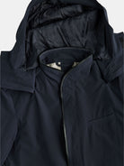 This close-up of a dark navy POCKETPARACHUTE® Tech Raincoat by gabrielstunz features a hood, front zipper, and small chest pocket. The smooth, slightly shiny material highlights its innovative fabric, delivering waterproof protection with packable convenience for any weather adventure.