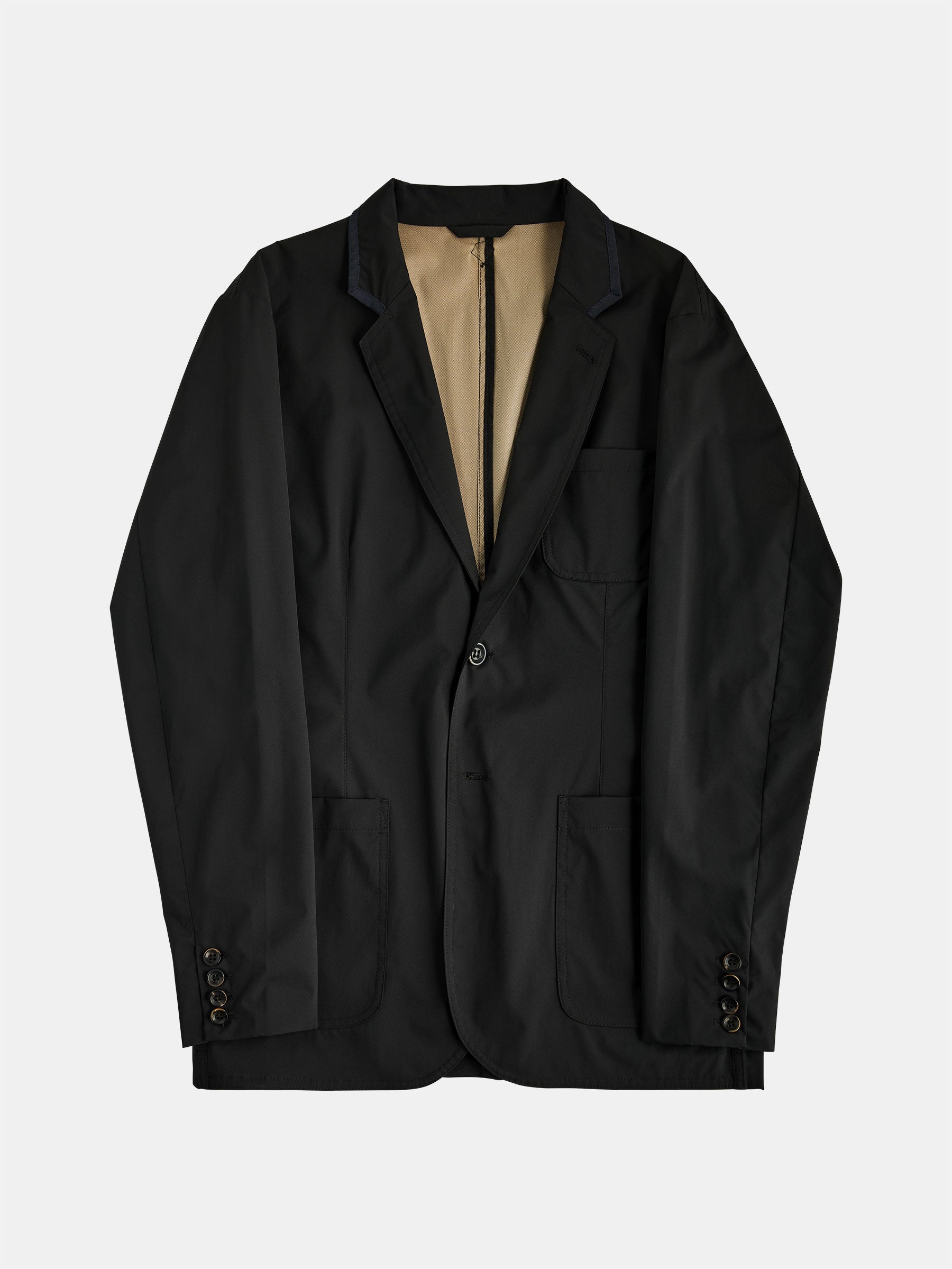 Presenting The Original POCKETPARACHUTE® by gabrielstunz, a versatile black blazer that seamlessly combines style and packable convenience. This water-repellent blazer is designed with a single button, two front pockets, a breast pocket, and cuff buttons. Featuring a beige lining for added flair, it's ideal for any unexpected adventure.