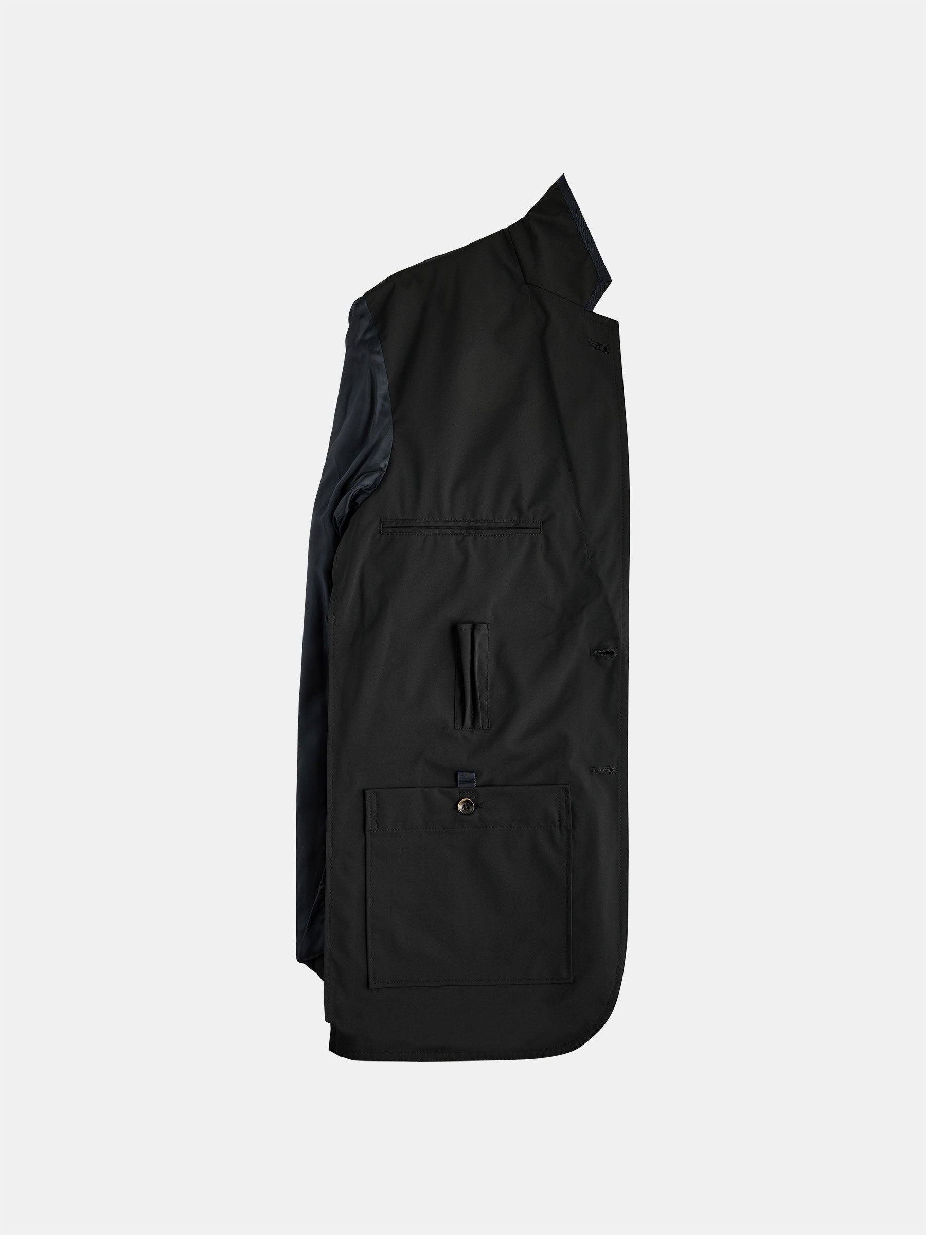 Side view of a black gabrielstunz The Original POCKETPARACHUTE® Jacket against a plain white background. The jacket features a buttoned pocket on the lower part and showcases a sleek, minimalist design with packable convenience, ideal for on-the-go wearability.