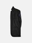 A sleek, dark-colored jacket from gabrielstunz's The Original POCKETPARACHUTE® collection is folded neatly with the side view facing up. It features a buttoned pocket and subtle stitching, set against a plain light grey background. This water-repellent blazer offers packable convenience for any adventure.